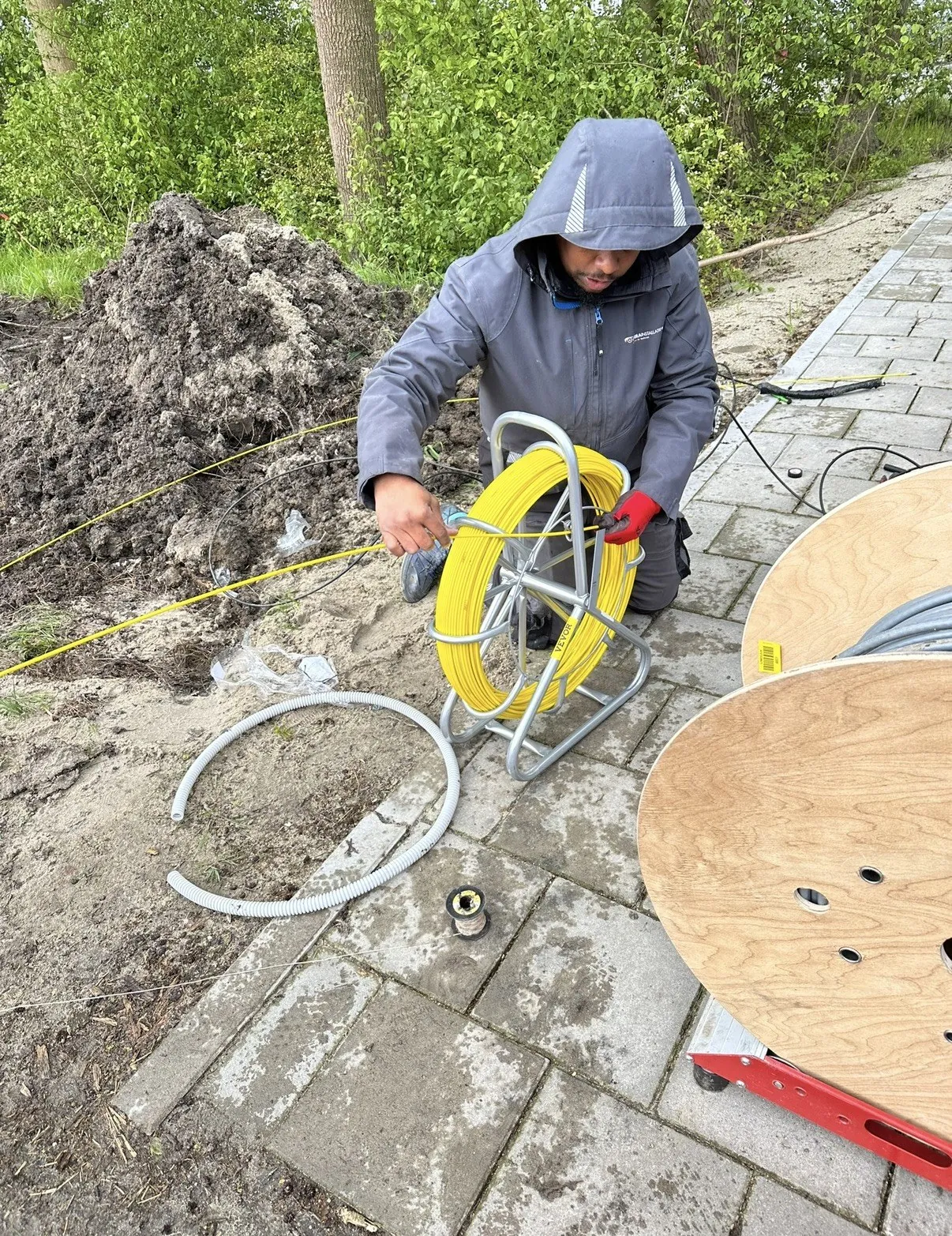 Glasvezel gaat met een rijgveer door de buis op een busstalling, op weg naar de volgende buitenkast