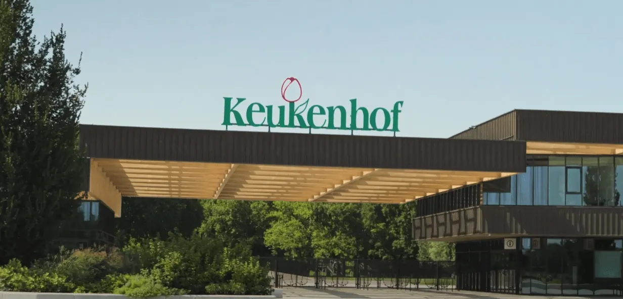 Ingang van park Keukenhof, Lisse, onder een houten kap met het groene logo